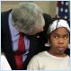 Picture of the Day: A girl reacts to President Bush leaning over her on MLK Day